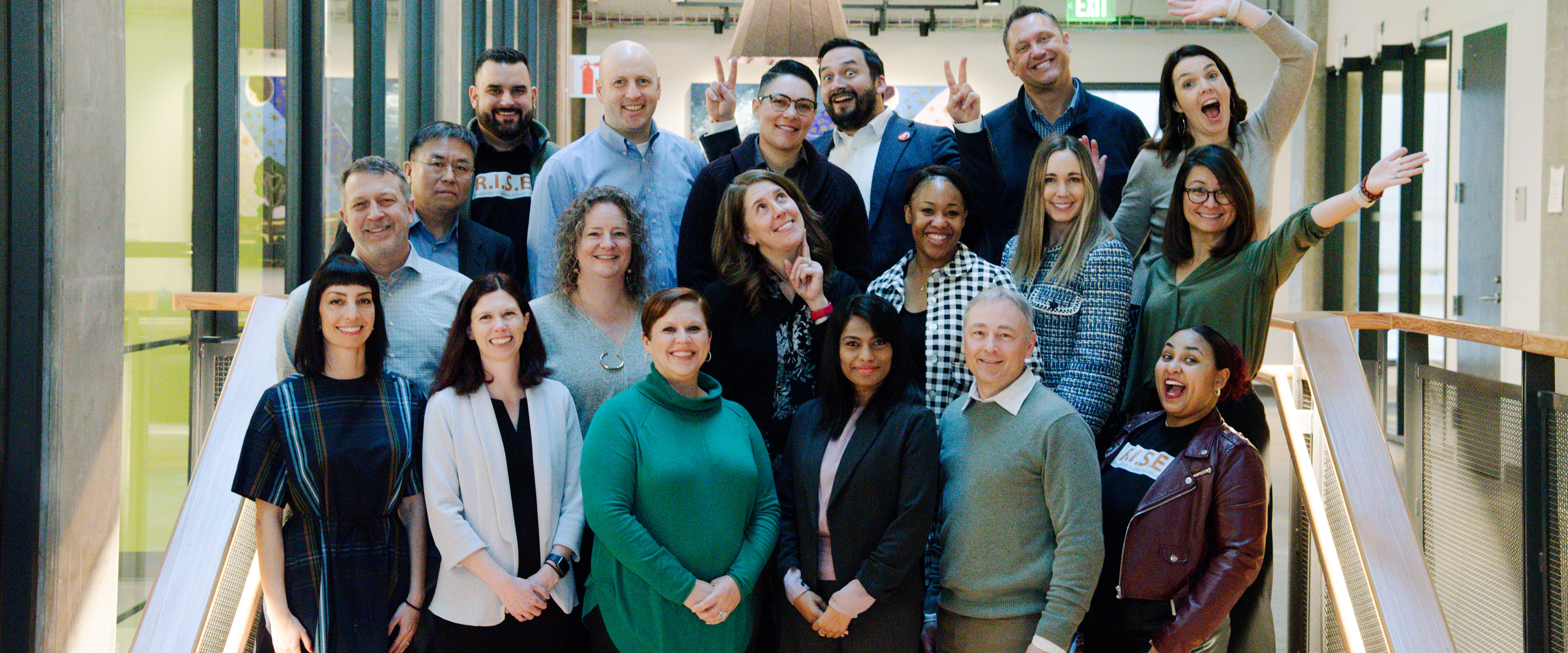 Group of smiling Seattle MBA students on a staircase