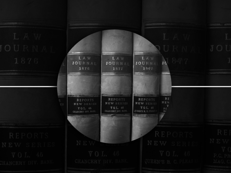 Law journal book spines on library shelf