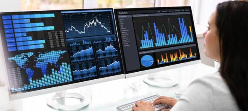 Professional reviewing screens showing bar graphs and maps