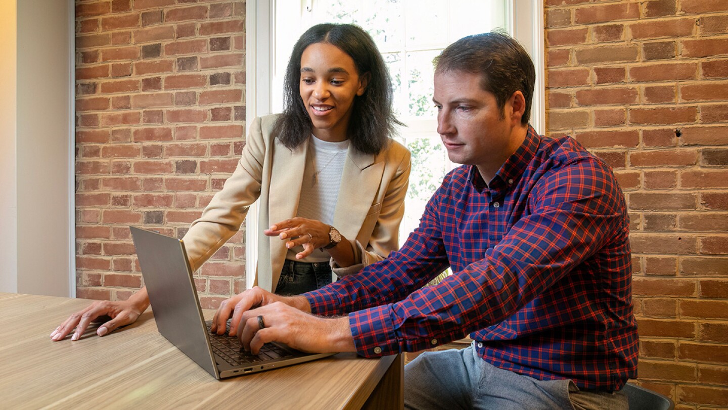 Man and women working on a laptop