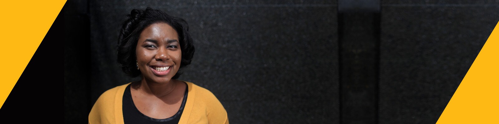 Smiling woman wears a yellow cardigan