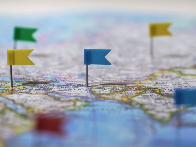 Locations marked with pins on world map, global communication ne