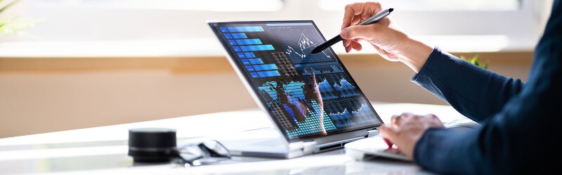 Business women working on a laptop with a KPI Business Data Dashboard Analytics.
