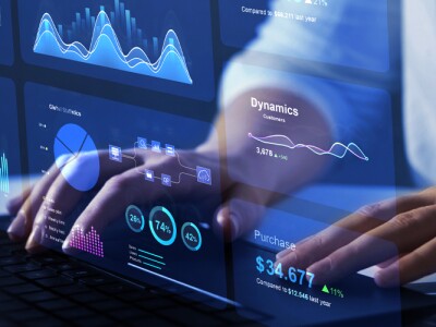 Advisor using metric dashboard on virtual screen to review analytics.
