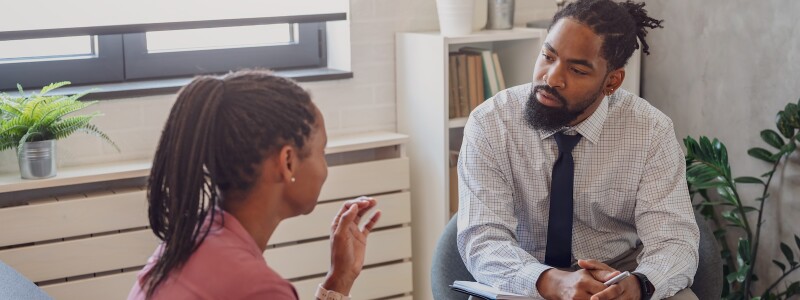 African American male counselor in session with African American female