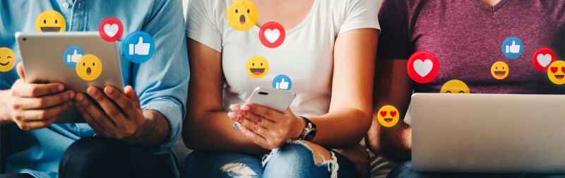 Group of people sitting together with social media reaction icons.