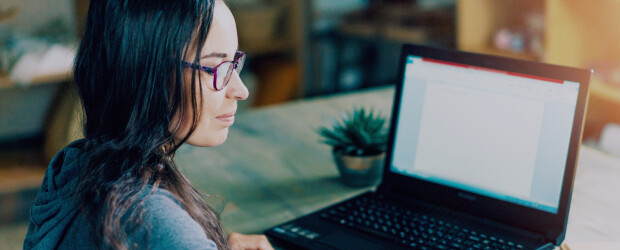 brunette-woman-at-laptop-in-glasses-succulent-next-to-computer