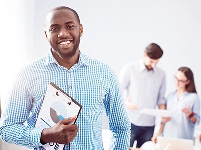 male student holding a clipboard showing pie chart