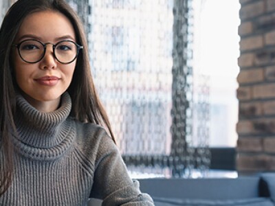 Confident student studying on laptop at cafe