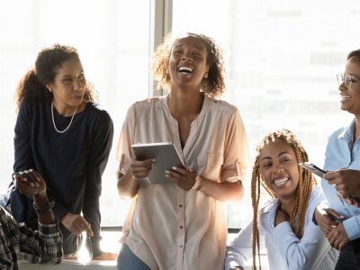 Friendly mixed-race team gather in office workplace for informal briefing.