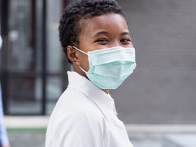 Happy woman wearing face mask, social distancing