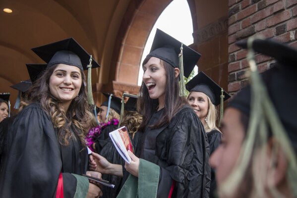Two graduates smiling