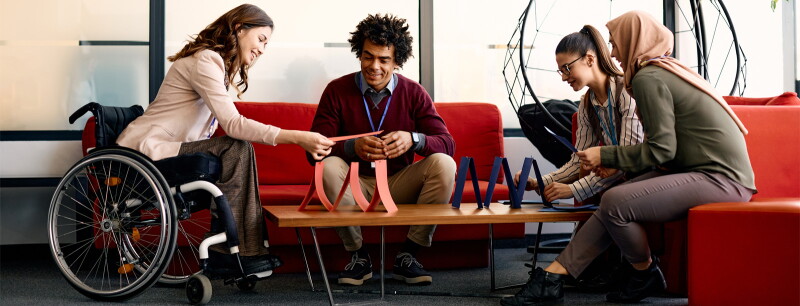 Multiracial business coworkers making house of cards on break in the office.