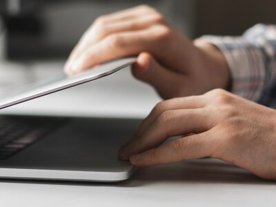 Man opens laptop computer to begin work