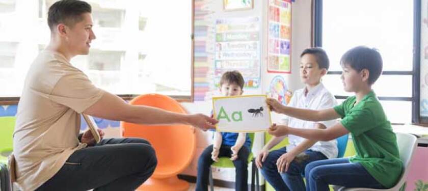 teacher-helping-young-students-learn-the-alphabet