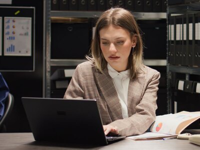 A woman working on a laptop.