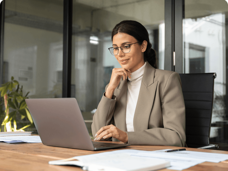 Professional woman using laptop at desk