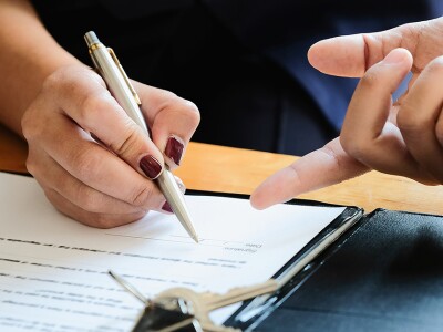 Real estate agent and customer signing a contract