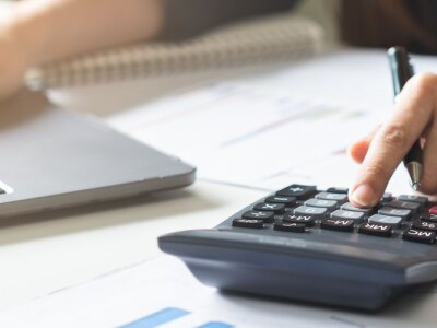 Young asian business woman hand using calculator.