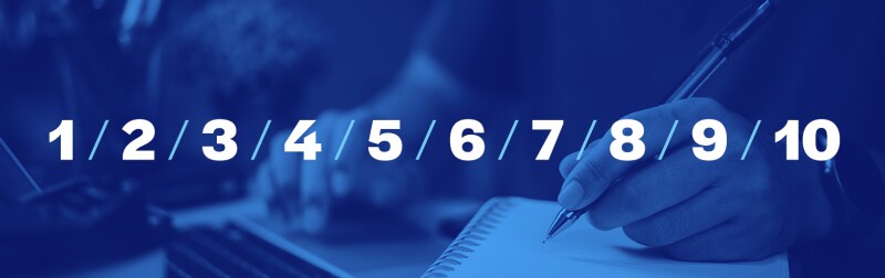 Man with pen writing a list in a notebook