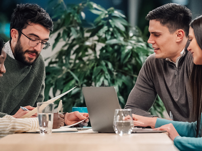 Colleagues discuss marketing strategy around a table