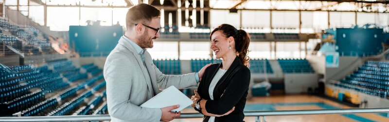 two executives in a sports arena