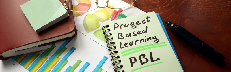 A spiral notebook with the words Project Based Learning written on it.