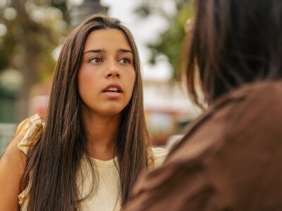 Teenager talking with a counselor outdoors.