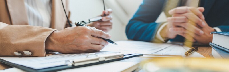 Two people discussing financial documents