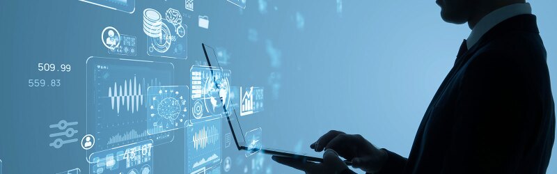 A business professional using AI-powered analytics on a laptop, surrounded by futuristic data visualizations.