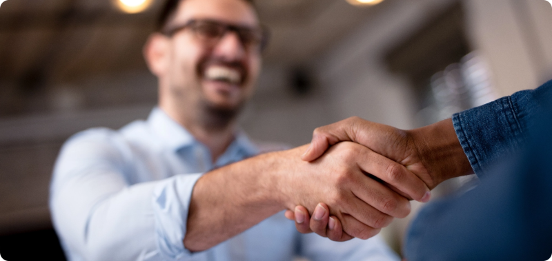 two men focus on shaking hands