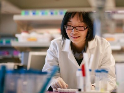 woman wearing a lab coat in a lab