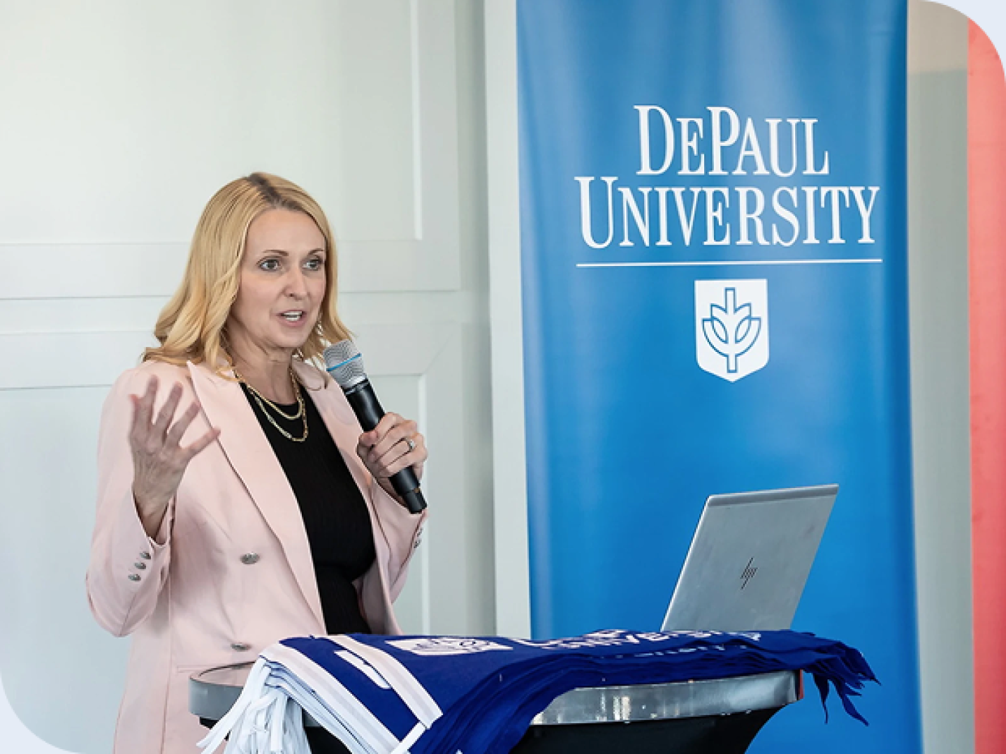 DePaul faculty member speaking in front of a podium