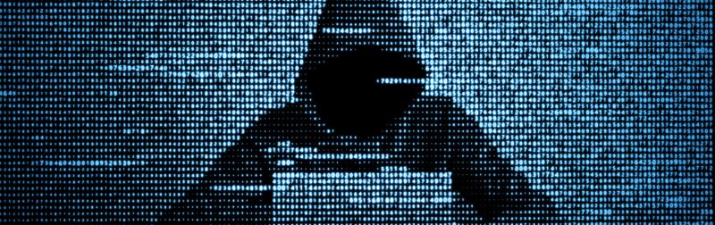 Hacker using laptop to conduct DoS attacks.