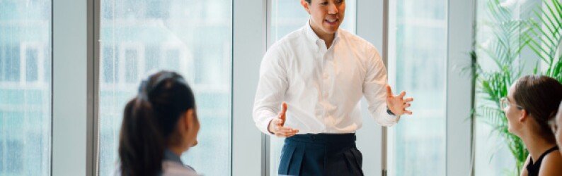renewable energy executive speaks to team in conference room