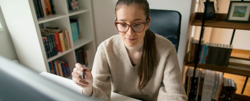 Woman working on computer at her home office