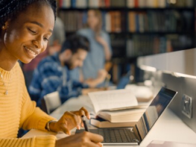 Woman focused on her laptop in a library