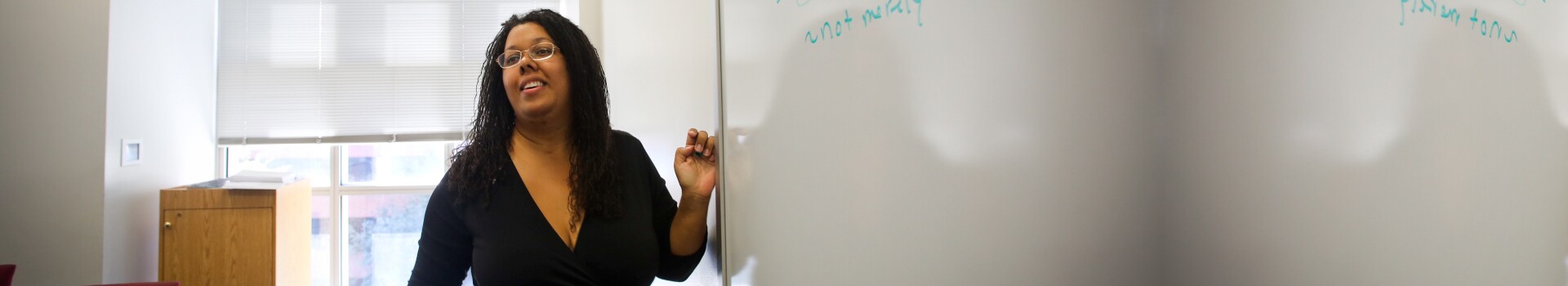 Professor Saru Matambanadzo stands at the whiteboard
