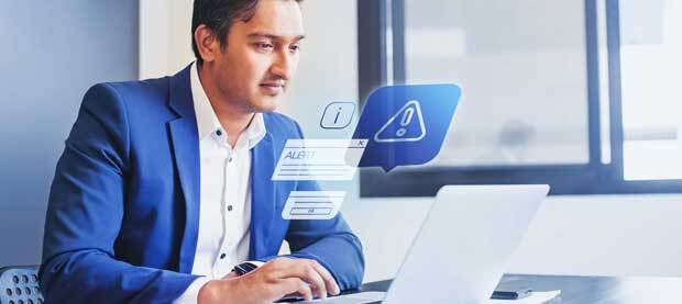 man in blue suit looking at computer with hazard sign and tabs in the air