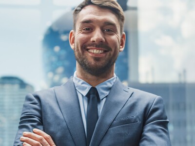 Successful businessman in the glass elevator of a modern office building