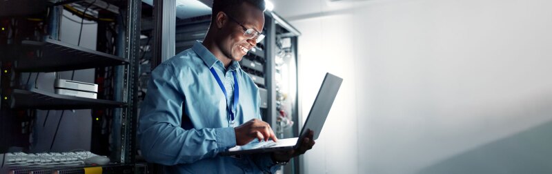 Professional Cybersecurity Analyst reviews server metrics in a data center.