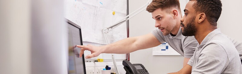 Engineers working at a computer