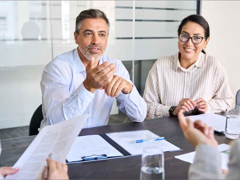 Diverse professional executive team working at meeting in office. Manager talking to board people consulting partners
