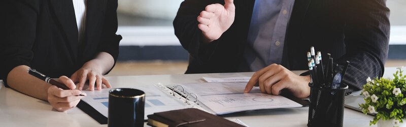 Corporate managers are reviewing documents to restructure the company.