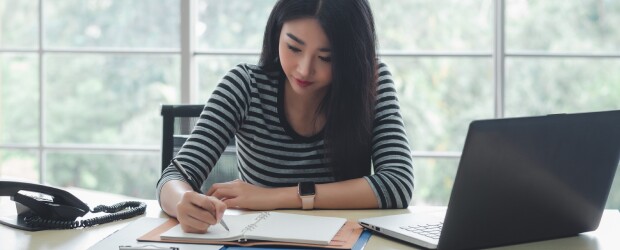 Woman studying focused at her desk