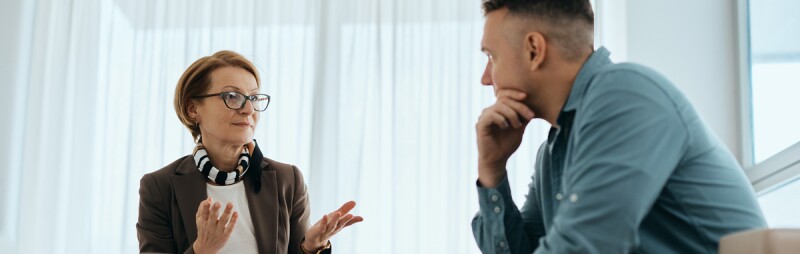 mental health counselor talking to man