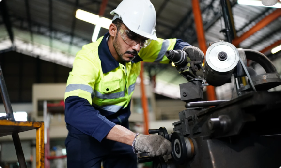 man in a workshop using mechanical tools
