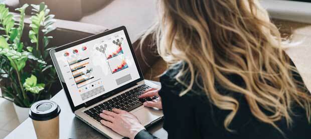 Person examining graphs on a laptop screen