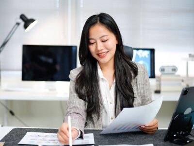 A female accountant check report for information, financial data or analysis.