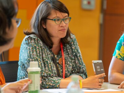 Group of teachers sitting around a conference table, brainstorming ideas for curriculum development.